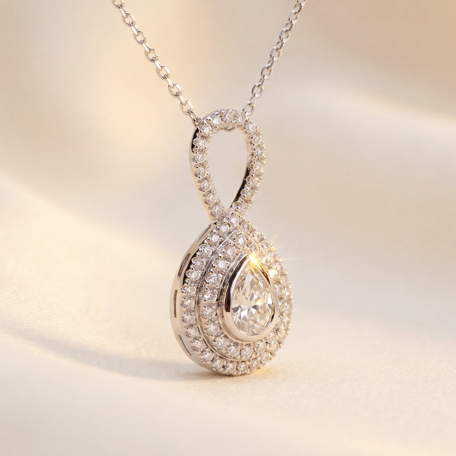 Diamond Pendant with a pear shape diamond and pave diamonds