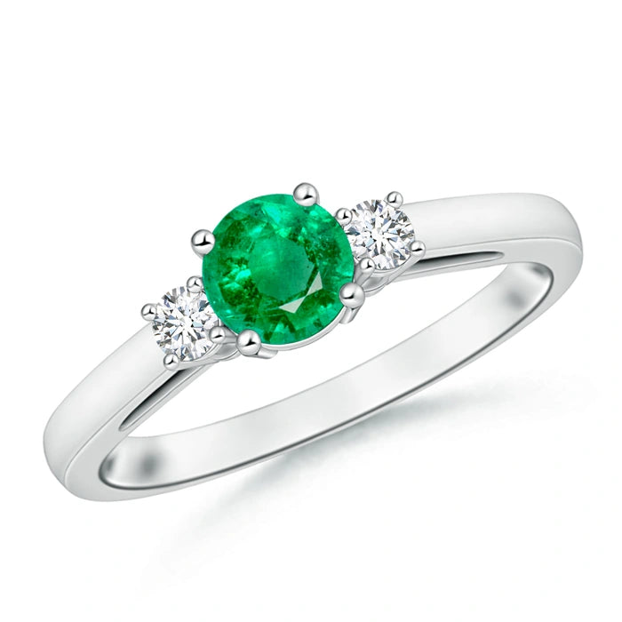 Slim white metal three stone ring, round green centre stone with one round white stone each side