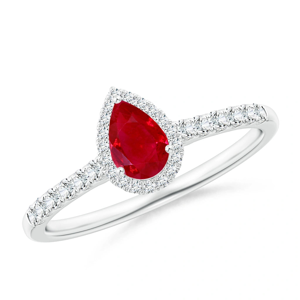 White metal ring with a pear-shaped ruby in a round diamond halo and diamond-set shoulders