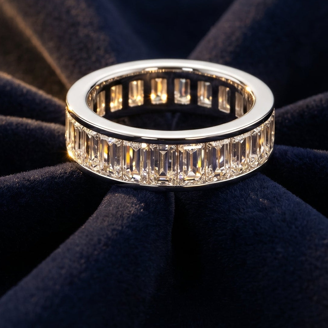 Platinum eternity ring with Baguette diamonds  on a dark blue fabric background
