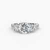 Three-stone ring with pavé band - elegant engagement ring featuring a central diamond and two side stones with pavé diamond detailing on the band