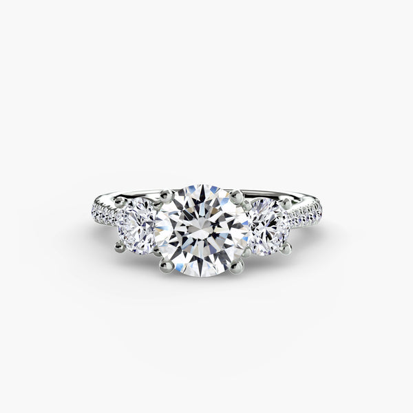 Three-stone ring with pavé band - elegant engagement ring featuring a central diamond and two side stones with pavé diamond detailing on the band