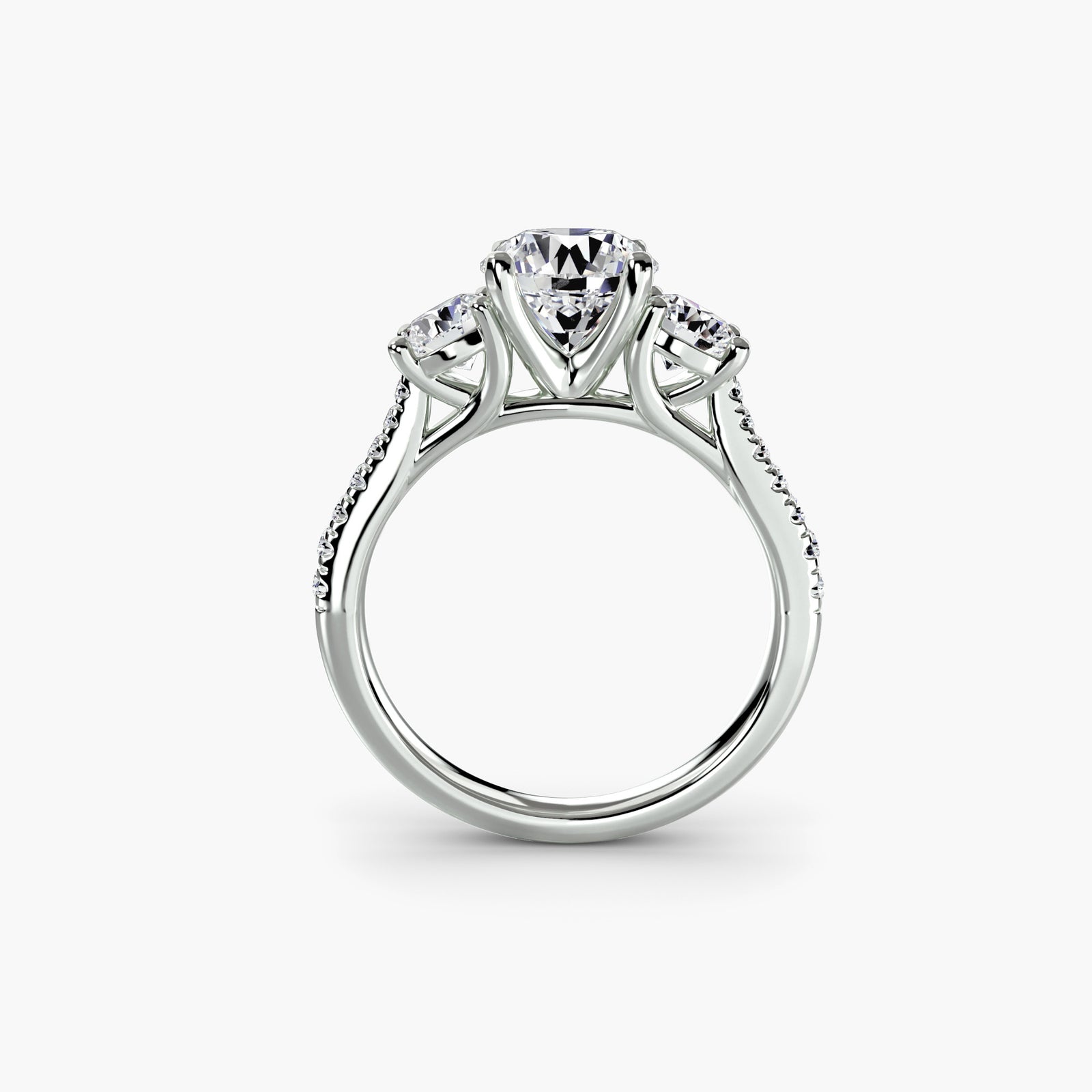 Three-stone ring with pavé band - elegant engagement ring featuring a central diamond and two side stones with pavé diamond detailing on the band