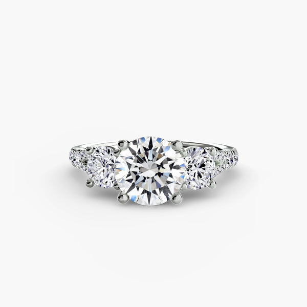Three-stone ring with pavé band 3 - timeless engagement ring featuring a central diamond and two side stones with pavé detailing on the band