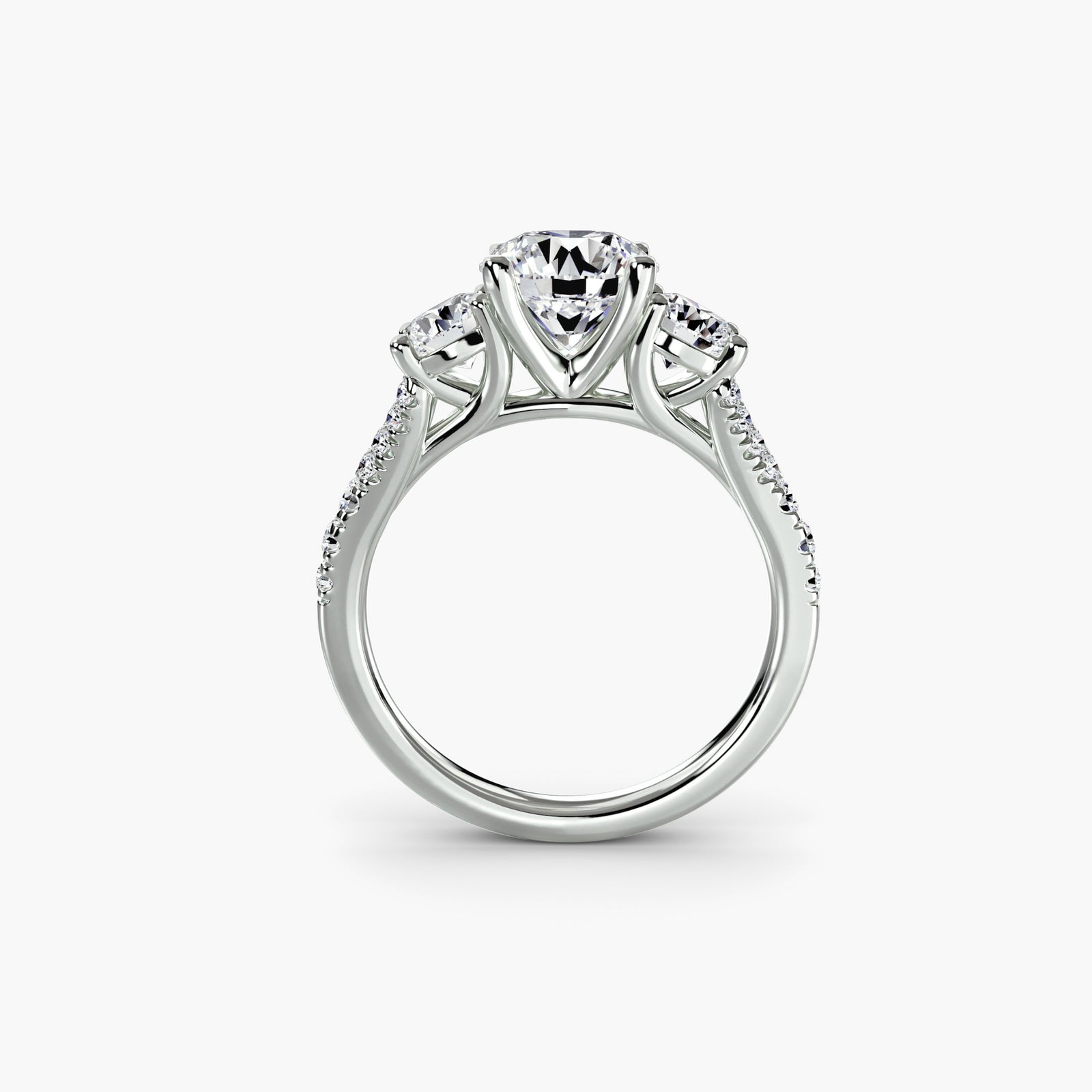 Three-stone ring with pavé band 3 - timeless engagement ring featuring a central diamond and two side stones with pavé detailing on the band