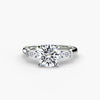 Three-stone ring with baguette side stones - elegant engagement ring featuring a central diamond with sleek baguette diamonds on the sides