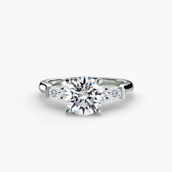 Three-stone ring with baguette side stones - elegant engagement ring featuring a central diamond with sleek baguette diamonds on the sides