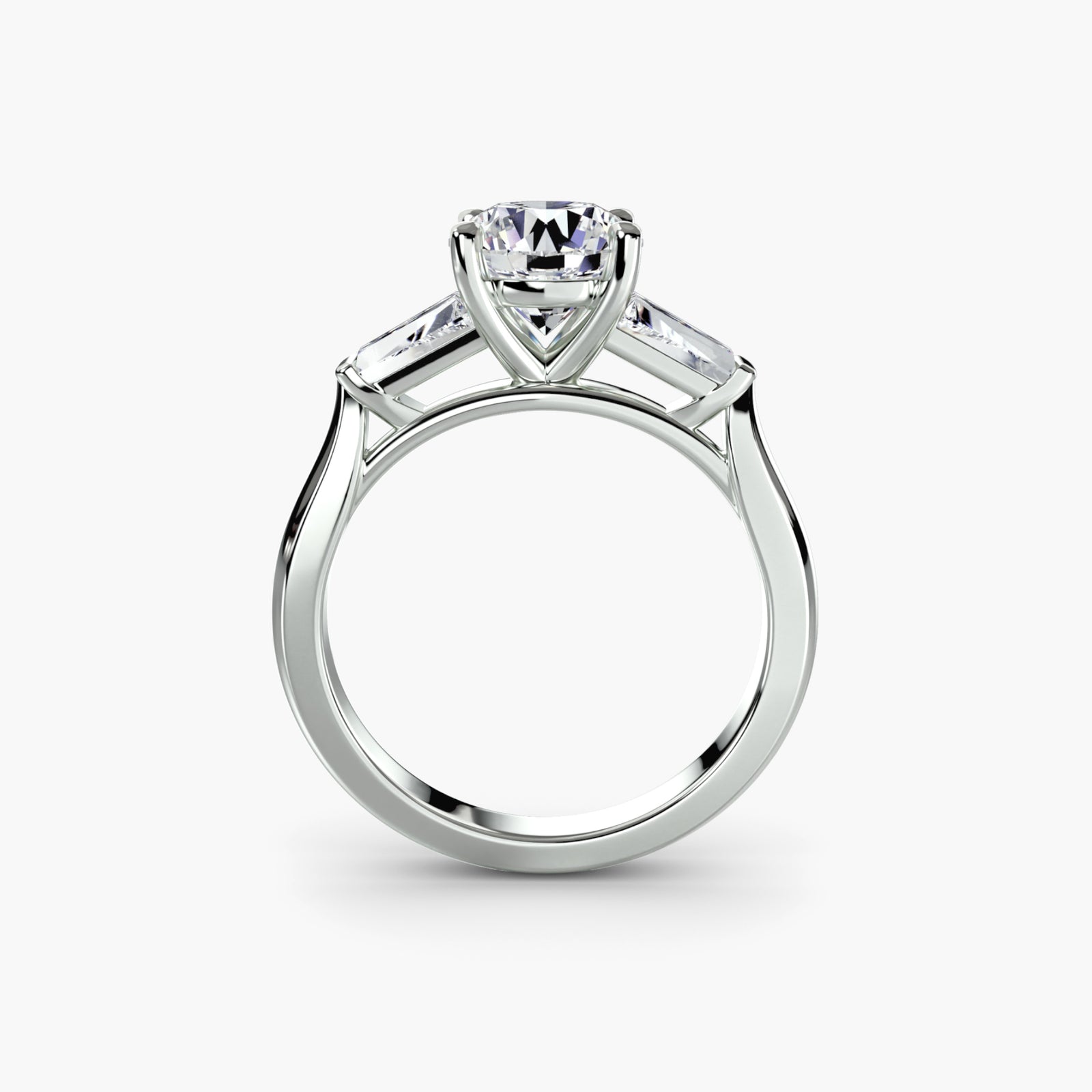 Three-stone ring with baguette side stones - elegant engagement ring featuring a central diamond with sleek baguette diamonds on the sides