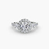 Three-stone ring with halo 2 - elegant engagement ring featuring a central diamond flanked by two side stones, surrounded by a sparkling halo
