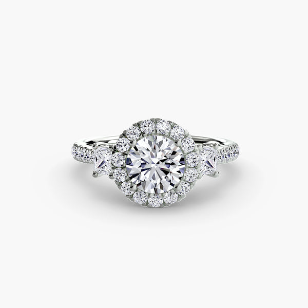 Three-stone ring with halo 2 - elegant engagement ring featuring a central diamond flanked by two side stones, surrounded by a sparkling halo
