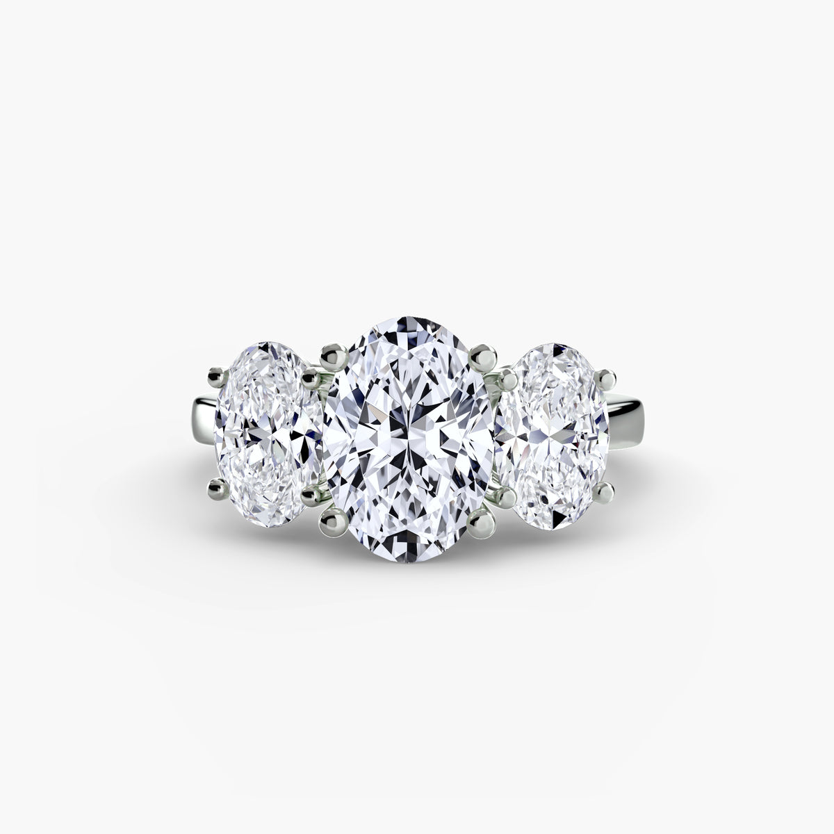 Trilogy Oval ring - classic three-stone engagement ring featuring an oval center diamond with two side diamonds
