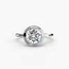 The Bezel Set Solitaire - modern engagement ring featuring a single diamond securely set in a sleek bezel setting