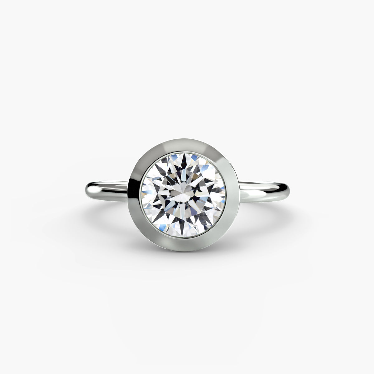 The Bezel Set Solitaire - modern engagement ring featuring a single diamond securely set in a sleek bezel setting