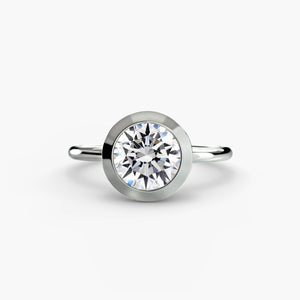 The Bezel Set Solitaire - modern engagement ring featuring a single diamond securely set in a sleek bezel setting
