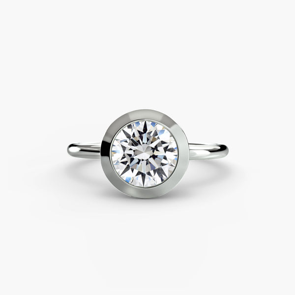 The Bezel Set Solitaire - modern engagement ring featuring a single diamond securely set in a sleek bezel setting