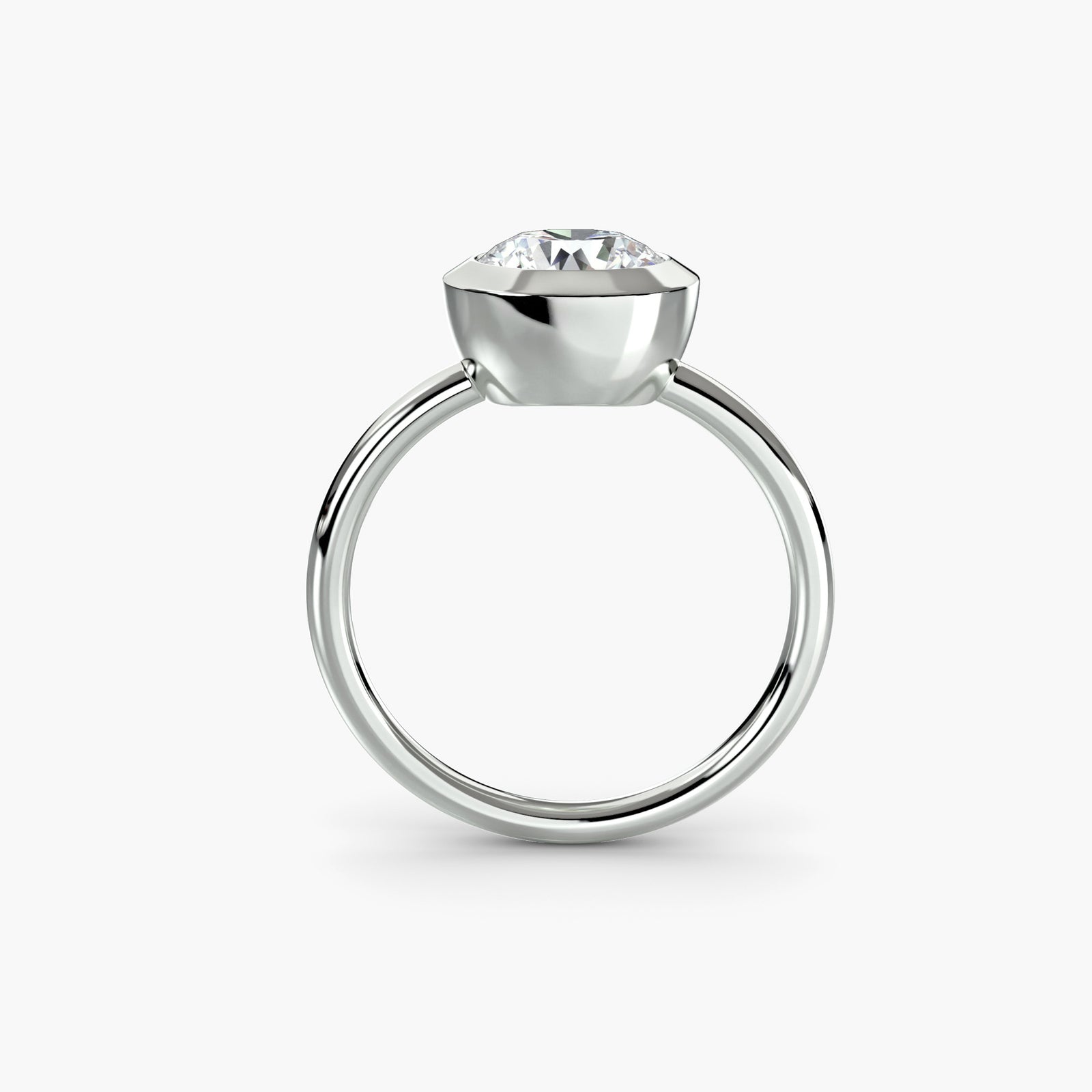 The Bezel Set Solitaire - modern engagement ring featuring a single diamond securely set in a sleek bezel setting