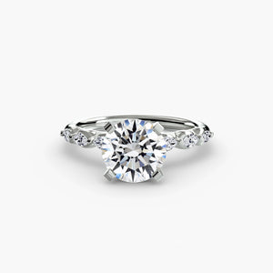 The Floral Accent Solitaire - elegant engagement ring featuring a central diamond with delicate floral-inspired accents on the band
