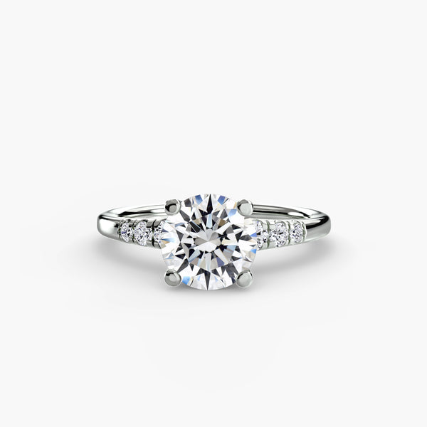 Solitaire with shoulder accents - classic engagement ring featuring a central diamond with accent diamonds on the shoulders for added sparkle