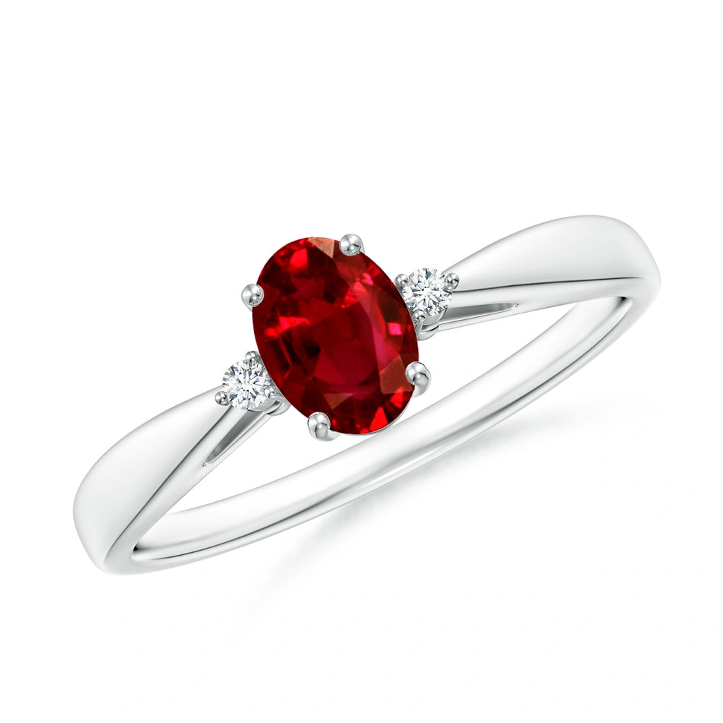 Slim tapered white metal ring with an upright oval ruby and one small round diamond each side