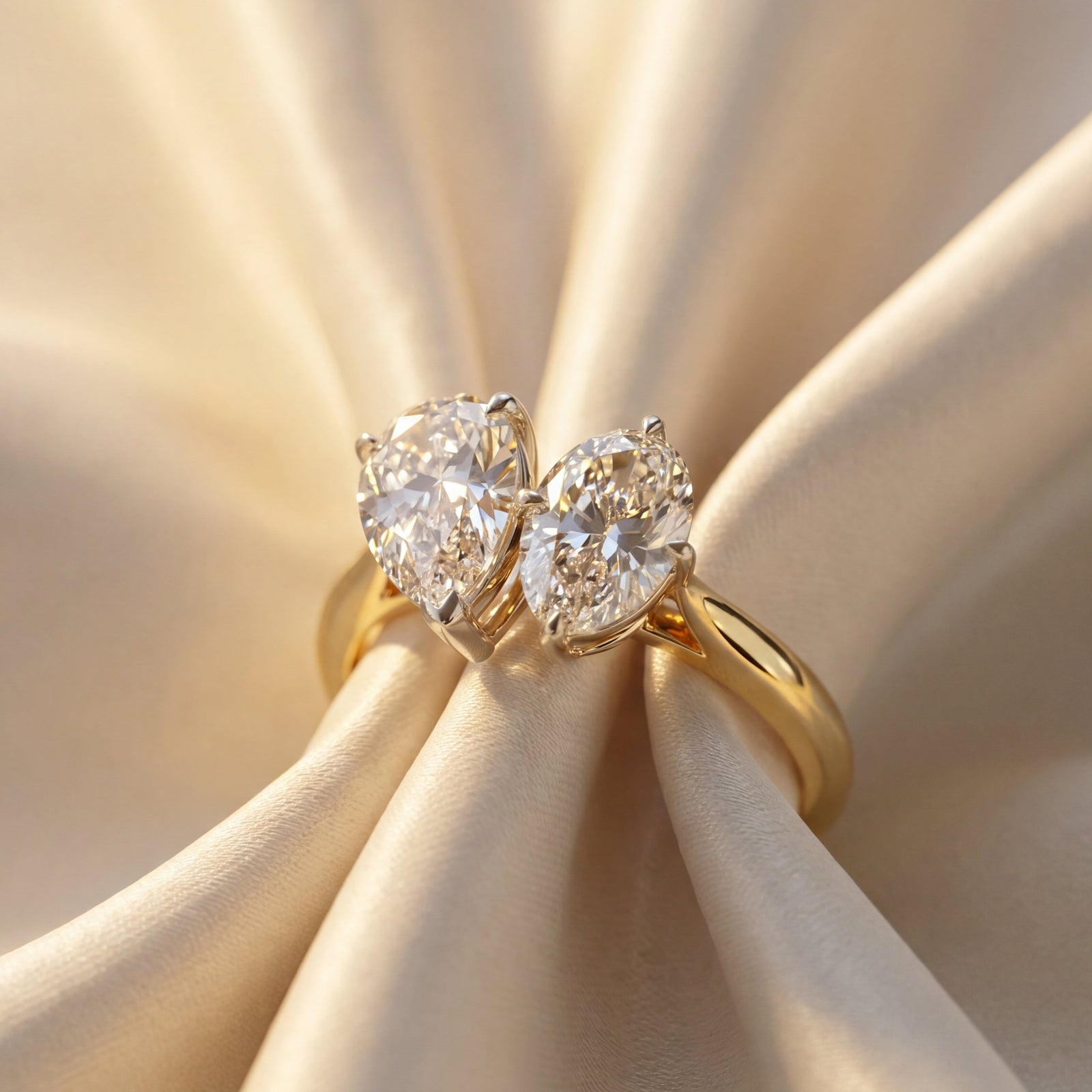 Toi et Moi Gold ring with and oval diamond and a pear shape diamond