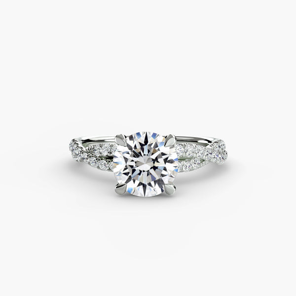 The Twisted Pavé Solitaire - elegant solitaire engagement ring with a twisted band adorned with pavé diamonds