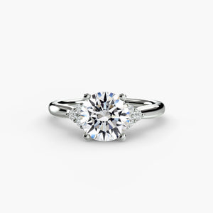 Solitaire with cluster shoulders - classic engagement ring featuring a central diamond with sparkling cluster accents on the shoulders