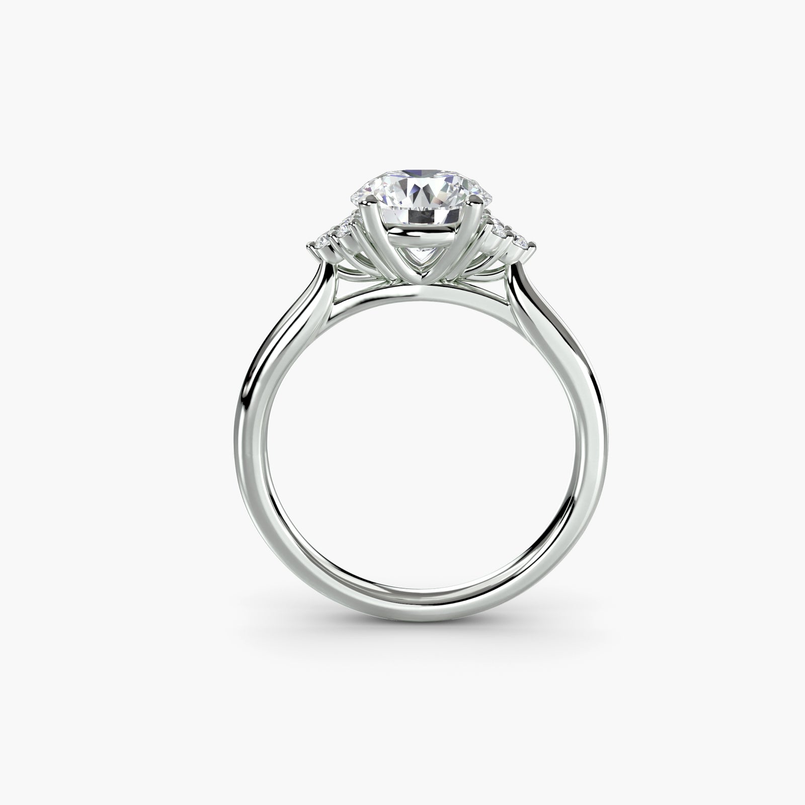 Solitaire with cluster shoulders - classic engagement ring featuring a central diamond with sparkling cluster accents on the shoulders