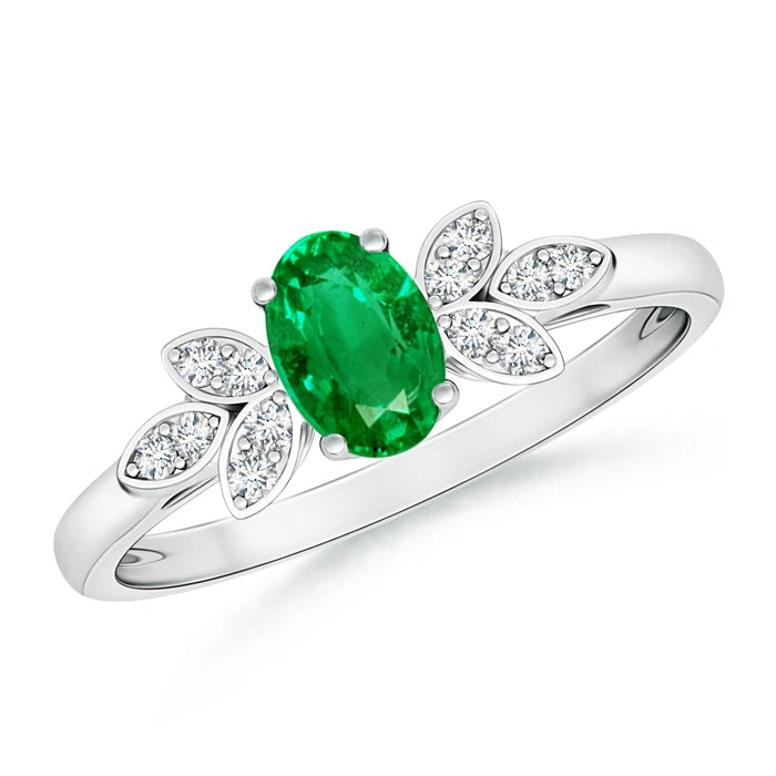 White metal ring with an oval green stone set between marquise shaped petals of small white stones