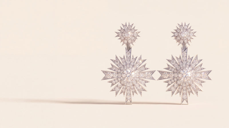A pair of diamond starburst drop earrings