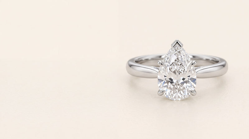 Pear shaped diamond solitaire engagement ring in platinum