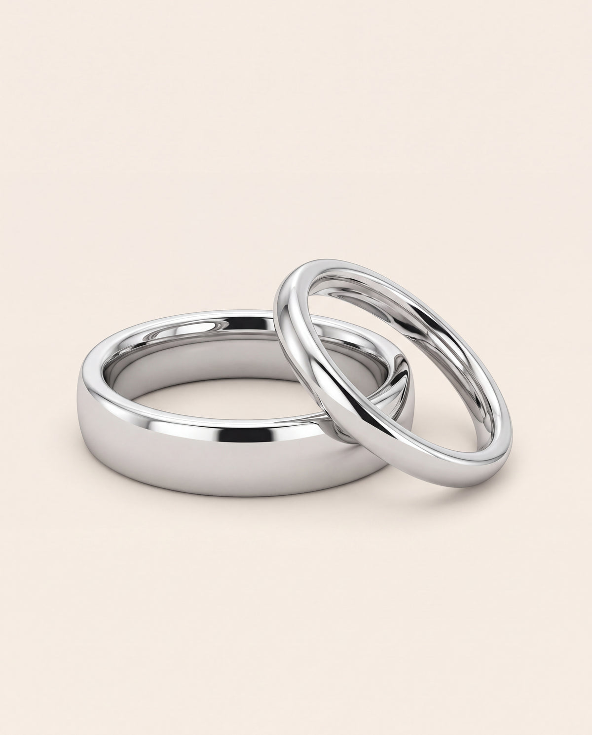A pair of plain wedding rings, one wider and one slimmer